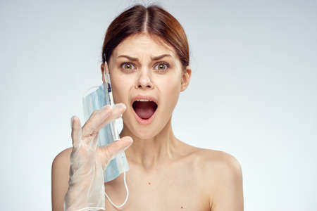 Young beautiful woman on white isolated background holds a syringe, doctor, medicine.の写真素材