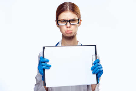 Young beautiful woman on white isolated background holds a syringe, doctor, medicine.の写真素材