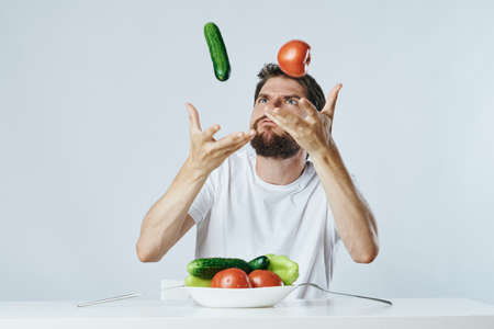 Vegetarian, diet, man with a beard on a white isolated background, nutrition, vegetables, vegetarianism.の写真素材