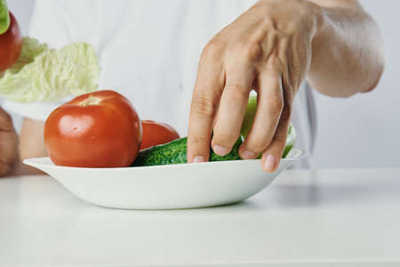 Vegetarian, diet, man with a beard on a white isolated background, nutrition, vegetables,...