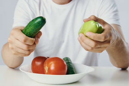Vegetarian, diet, man with a beard on a white isolated background, nutrition, vegetables,...