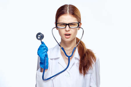 Young beautiful woman on a white isolated background, doctor, scientist, medicine.