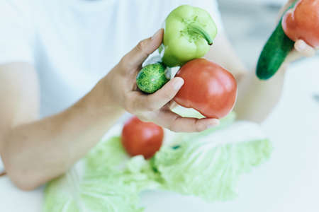 Man with a beard on a light background, vegetables, diet, vegetarianism, vegetarian.の写真素材