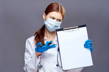 Beautiful young woman on a black background, doctor, medicine.の写真素材