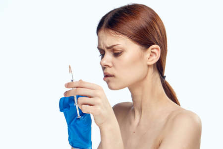 Young beautiful woman on white isolated background, plastic surgery, medicine, nurse.