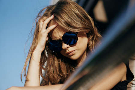 Young beautiful woman in sunglasses outside in the city, portrait.の写真素材