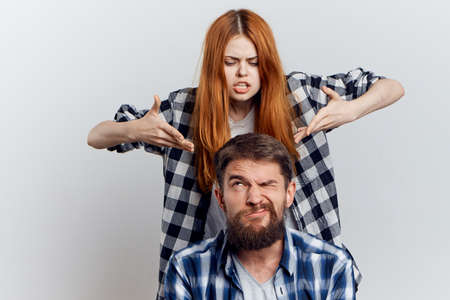 Man with a beard on a light background with a young beautiful woman, emotions.の写真素材