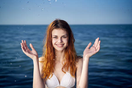 Young beautiful woman in a swimsuit resting on the sea, splashing, water, vacation.