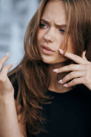 Young beautiful woman on a light background, portrait, emotions.の写真素材