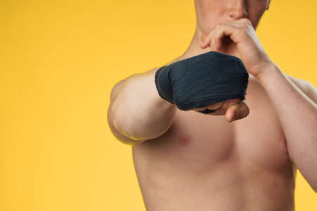 Young guy athlete on a yellow background, sport.の写真素材