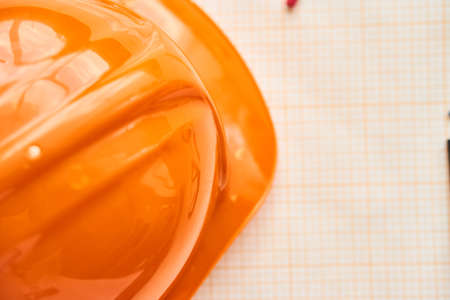 Orange construction helmet, drawing paper.の写真素材