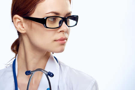 Doctor woman in glasses works in the hospital.の写真素材