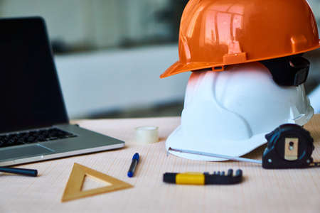Table, engineer, work, construction, blueprints, helmet, tube.の写真素材
