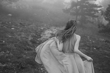 Black and white photo, woman running in the forest.の写真素材