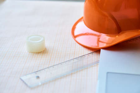 Workplace builder, half a laptop, drawing paper on the table, ruler drawing.の写真素材