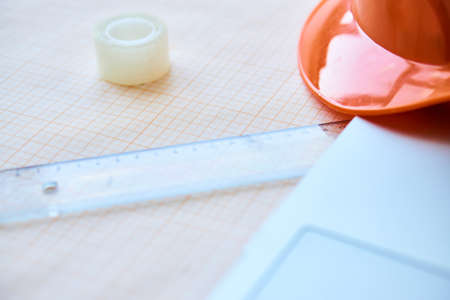 Half of a construction helmet, a drawing line, a laptop, design of works.の写真素材