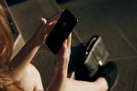 Woman holding a phoneの写真素材