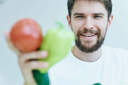 Man with a beard holding vegetablesの写真素材