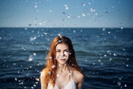 Happy woman on the sea in summer timeの写真素材