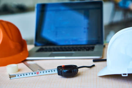 Helmets, laptop, roulette, builder's workplace, drawing paper.の写真素材