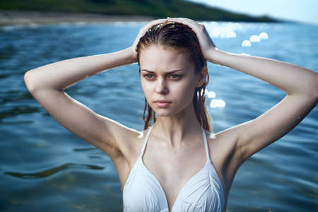 Beautiful young woman bathing in the sea in a swimsuit, vacation, beach, sun, summer.の写真素材
