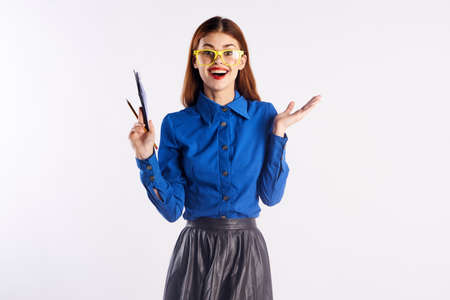 Young beautiful woman in glasses on a light background, smile, fashion, teacher.