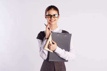 Young beautiful woman in glasses on a white background, teacher, teach, director, study.