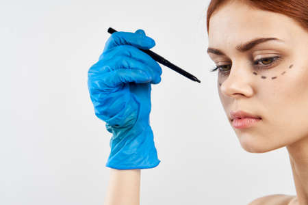 Young beautiful woman on a white background, facial contour, plastic surgery.の写真素材