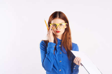 Young beautiful woman in yellow glasses on white isolated background, teacher.の写真素材