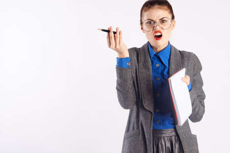 Young beautiful woman in glasses on white isolated background, emotions, teacher, teach, study.の写真素材