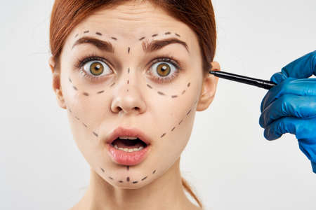 Beautiful young woman on white isolated background, portrait, plastic surgery, emotions.の写真素材