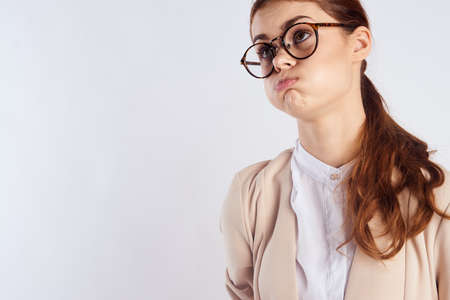 Beautiful young woman in glasses on white isolated background, teacher, portrait, emotions.の写真素材