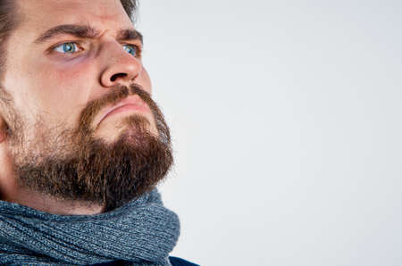 Man with beard on white isolated background, portrait, cold, emotion.