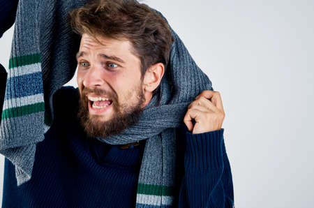 A man with a beard on a light background, a cold, a disease.の写真素材