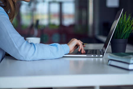 Woman working at the computer in the office, business, work.