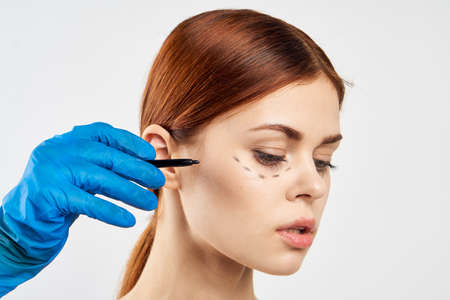 Young beautiful woman on white isolated background, plastic surgery, portrait.