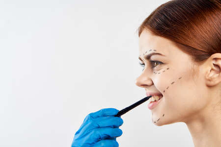 Young beautiful woman on white isolated background, plastic surgery, portrait, smile, blank space for copy.の写真素材