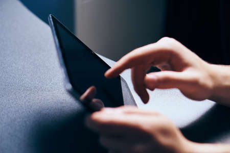 Woman holds a tablet, hands, touch, sensor, screen, technology.の写真素材