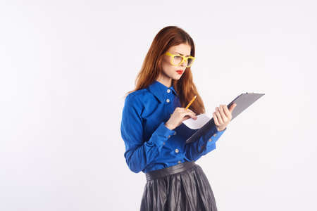 Young beautiful woman holding documents on white isolated background.の写真素材