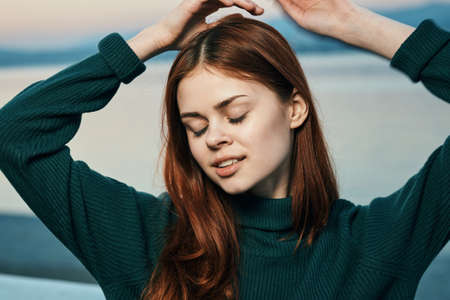 Woman dreams, on the background of the sea, embankment.の写真素材