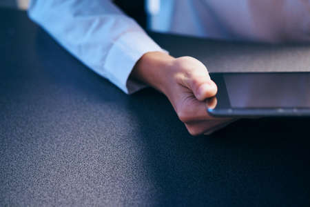 Woman in shirt holding tablet, hands, close-up, sensor, screen.の写真素材