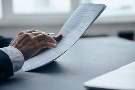 Business man holding documents close-up.