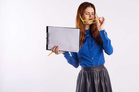 Woman in glasses holds documents, teacher.の写真素材