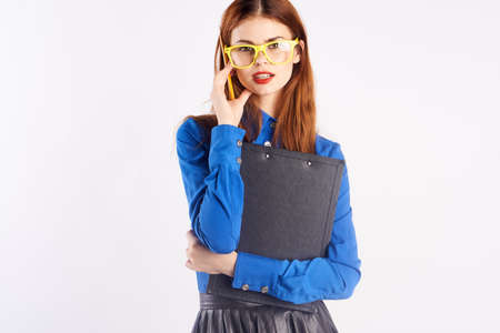 Woman in glasses holds documents, teacher, business.の写真素材