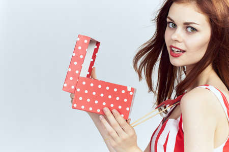 Woman holding a box, gift, red.の写真素材
