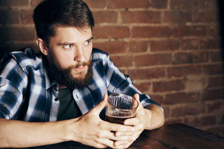 A man drinks beer in a bar.の写真素材