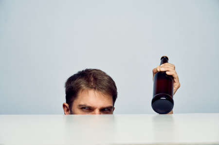 The man looks out from under the table.の写真素材