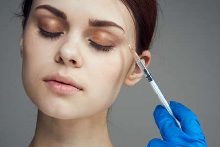 Woman, syringe, face.の写真素材