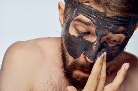 Clay cosmetic face mask, man, portrait.の写真素材
