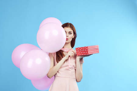 Woman holding balloons in a dress.の写真素材